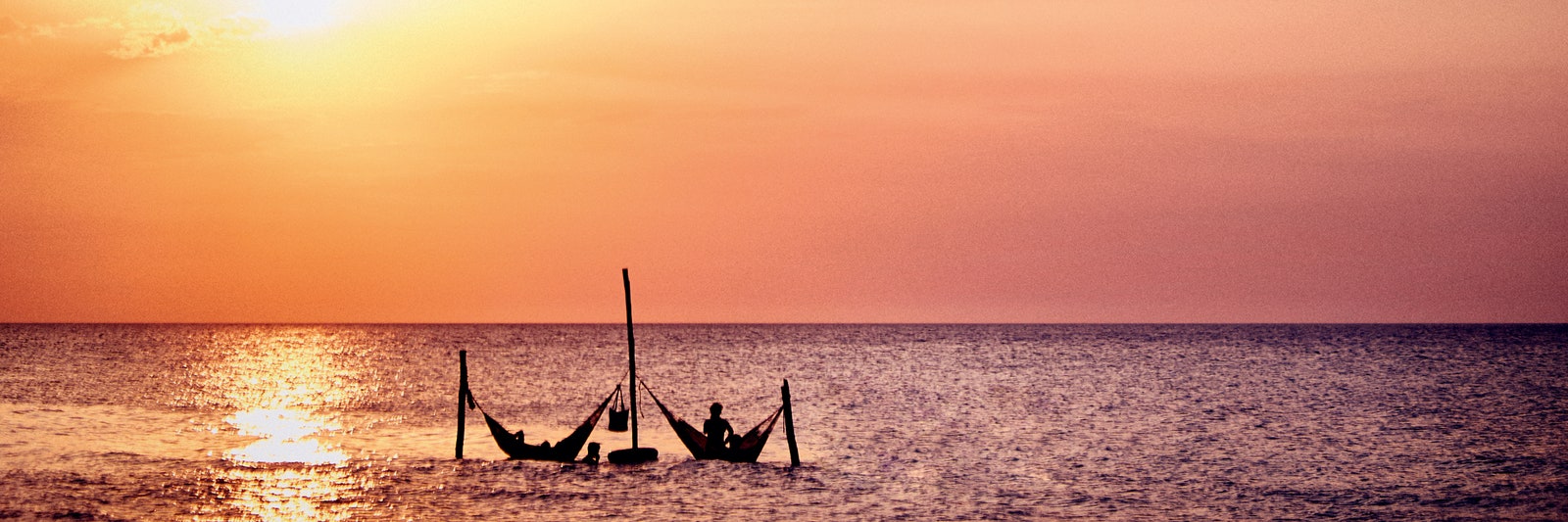 Image may contain Nature Outdoors Sky Boat Sailboat Transportation Vehicle Sunrise Sunlight Horizon and Sunset